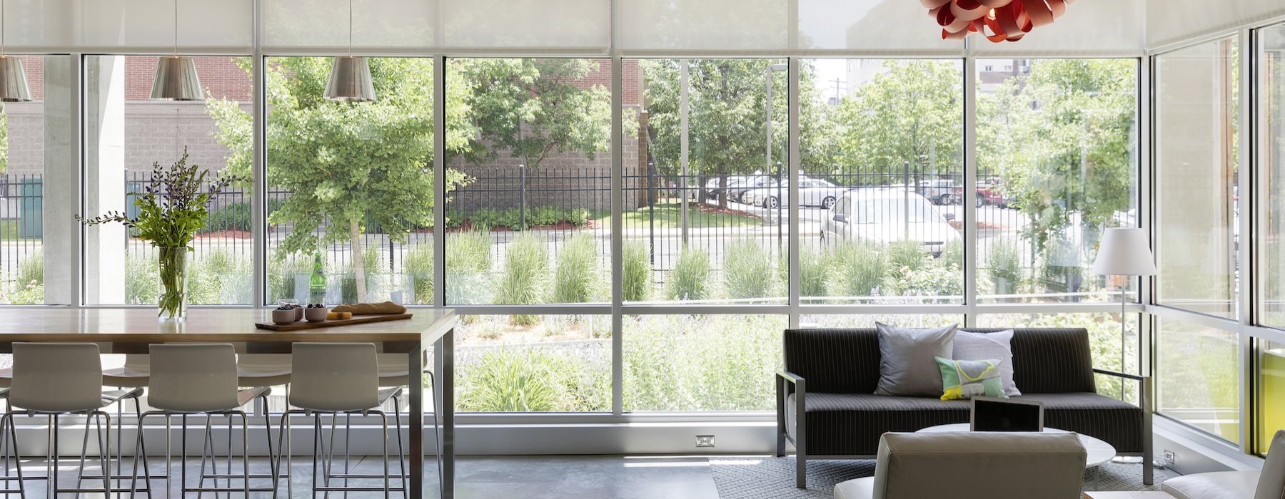 a clubroom with tables, chairs and windows