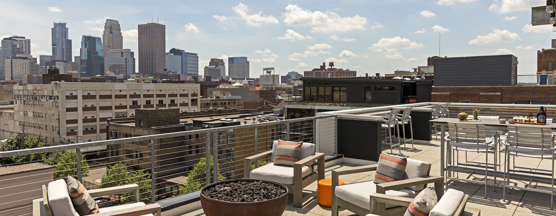 a rooftop fire pit with chairs
